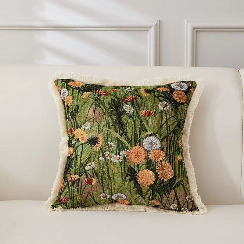 Thea Dandelion Meadow Cushion with cream fringe on a sofa