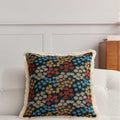 Edith Midnight Meadow Cushion, dark ditsy floral tapestry on a sofa