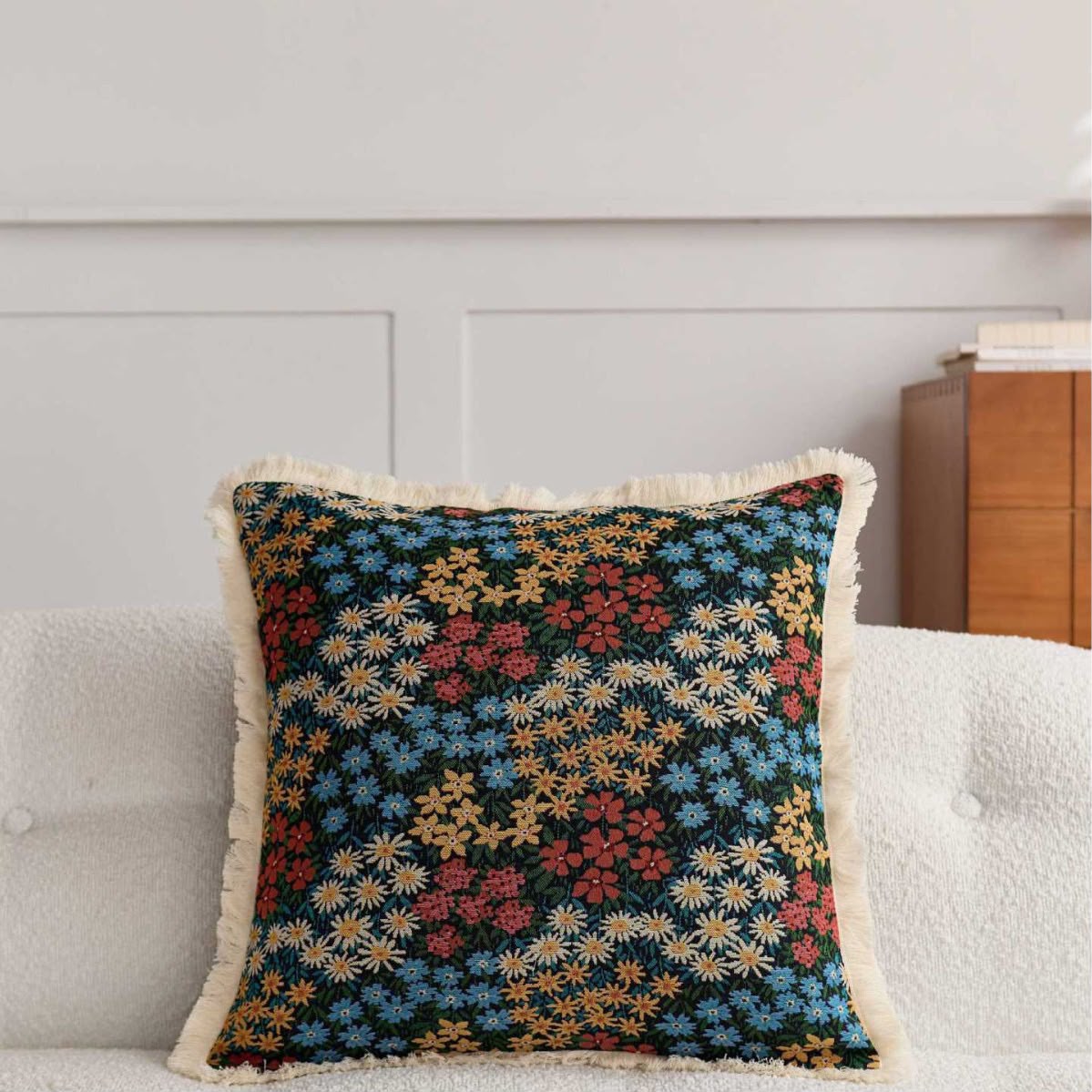 Edith Midnight Meadow Cushion, dark ditsy floral tapestry on a sofa