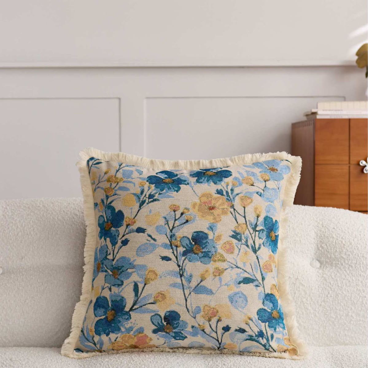 Celia Blue Blossom Cushion, blue and yellow floral tapestry on a sofa