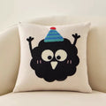 Wilma Happy Soot Cushion, cream cushion with a black embroidered character in a striped party hat