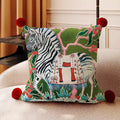 Oona Zebra Chinoiserie Cushion, green painted zebra among foliage with red pom-pom corners