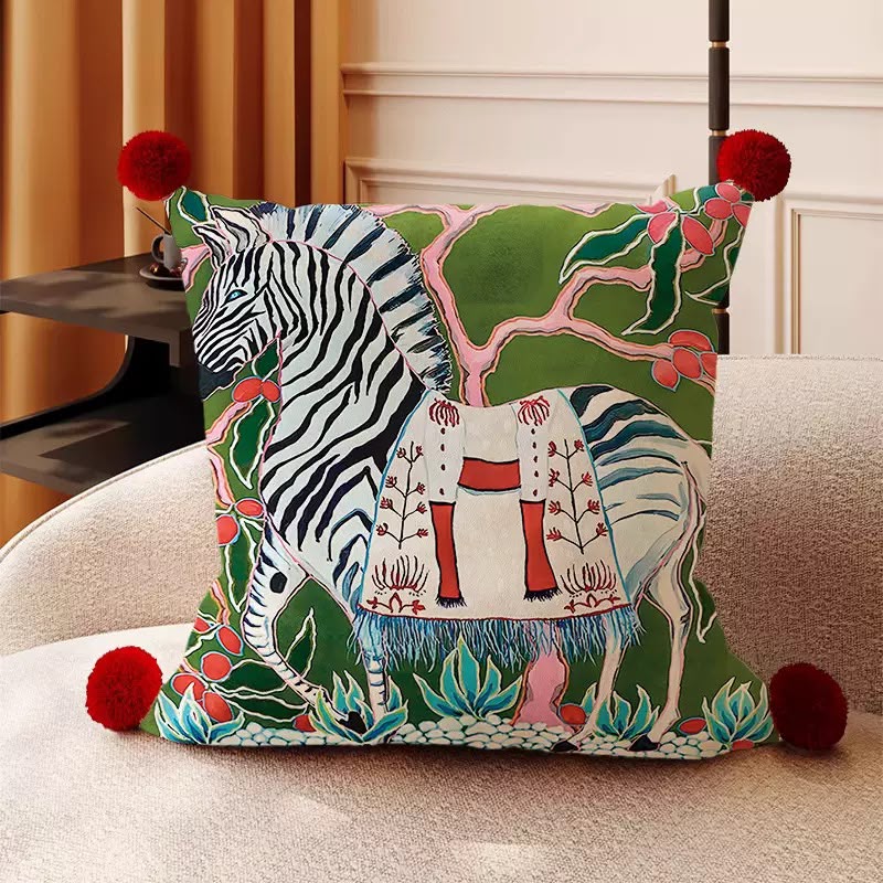 Oona Zebra Chinoiserie Cushion, green painted zebra among foliage with red pom-pom corners