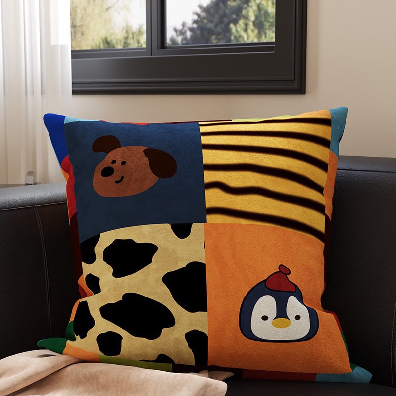 Scout Patchwork Penguin and Pup Cushion, colour-block panels with a brown pup, tiger stripes, cow print and a penguin