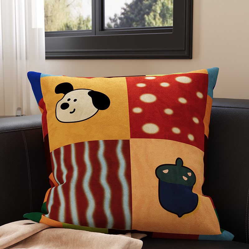 Pepper Patchwork Acorn Pup Cushion, colour-block panels with a black and white pup, spots, stripes and an acorn