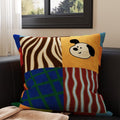 Quinn Patchwork Grid Pup Cushion, colour-block panels with zebra stripes, a black and white pup, blue grid and red stripes