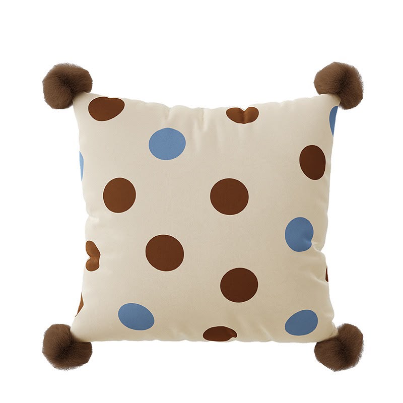 Bonnie Cocoa Spot Cushion, cream with brown and blue spots and pom-pom corners