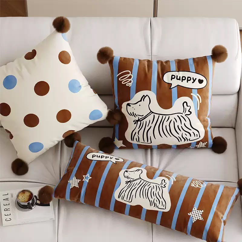 Maple Puppy Stripe Cushion on a sofa with the matching bolster and spot cushion