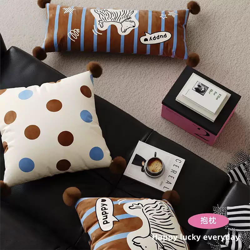 Puppy cushion set styled on a dark sofa