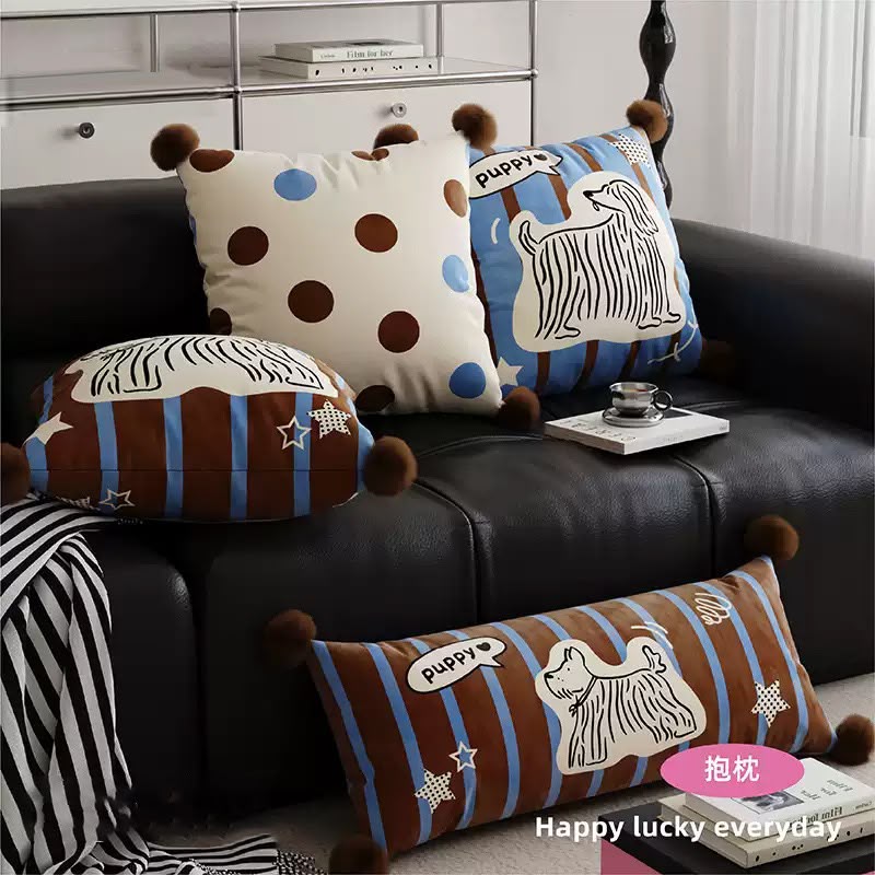 Puppy cushions grouped on a leather sofa
