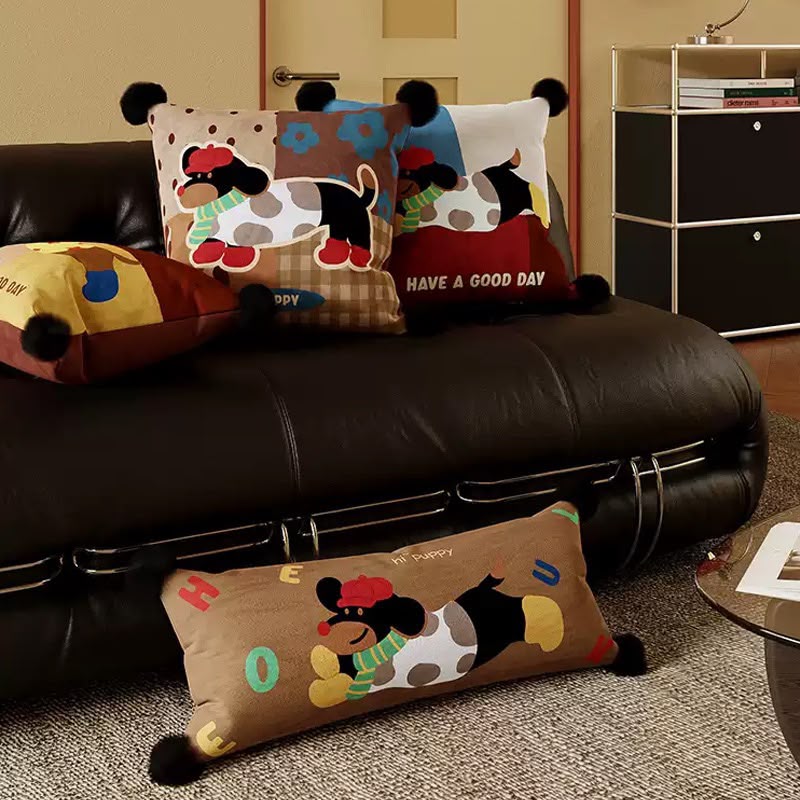 Puppy bolster with the matching patchwork cushions on a sofa