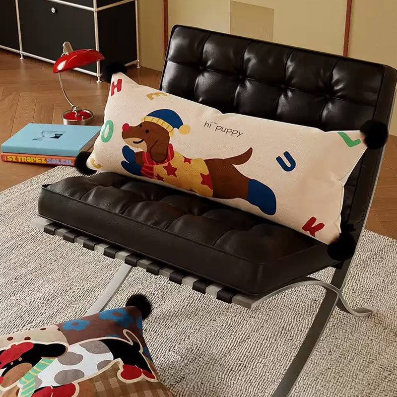 Puppy bolster cushion on a leather chair