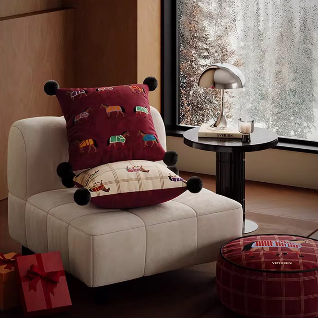 Horse cushions on a cream armchair