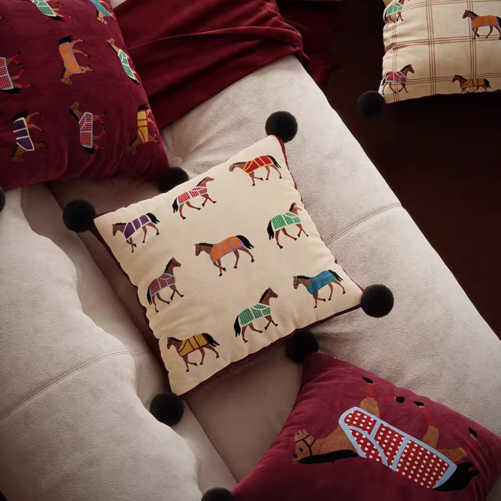 Horse cushions arranged on a sofa