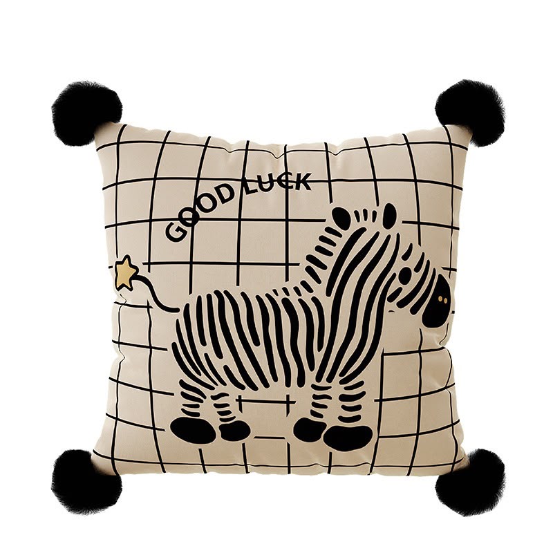 Nina Good Luck Zebra Cushion, cream grid cushion with a zebra print and black pom-pom corners