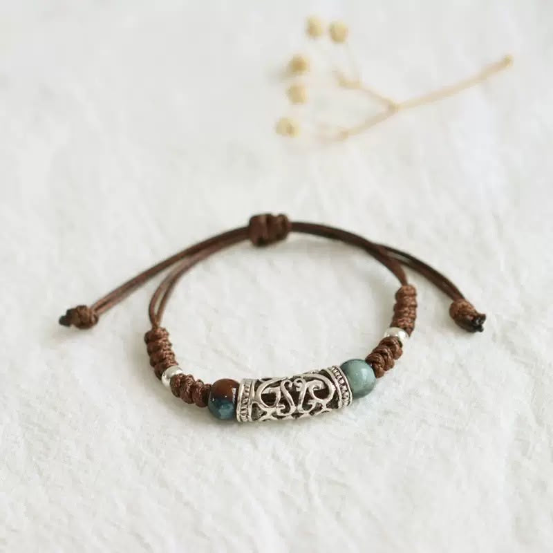 Edith turquoise bead cord bracelet — adjustable brown waxed cord with a silver filigree bead and turquoise-blue ceramic beads