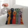 Mabel Curious Cats Cushion, row of brightly stitched cats on a cream cover