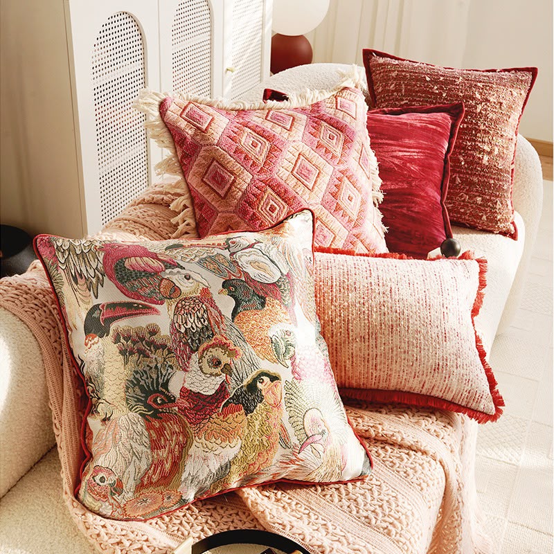 The pink and red cushion collection styled together on a daybed