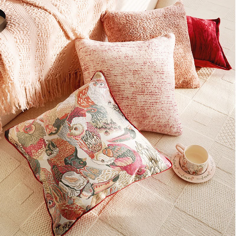 The pink and red cushion collection styled on a rug