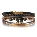 Dorothy black stone chip leather bracelet — layered black and tan leather strands with black stone chips, gold-tone bar and magnetic clasp
