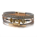 Nora moss stone chip leather bracelet — layered grey and tan leather strands with grey-green stone chips, gold-tone bar and magnetic clasp