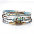 Clementine turquoise stone chip leather bracelet — layered blue and silver leather strands with turquoise stone chips, gold-tone bar and magnetic clasp