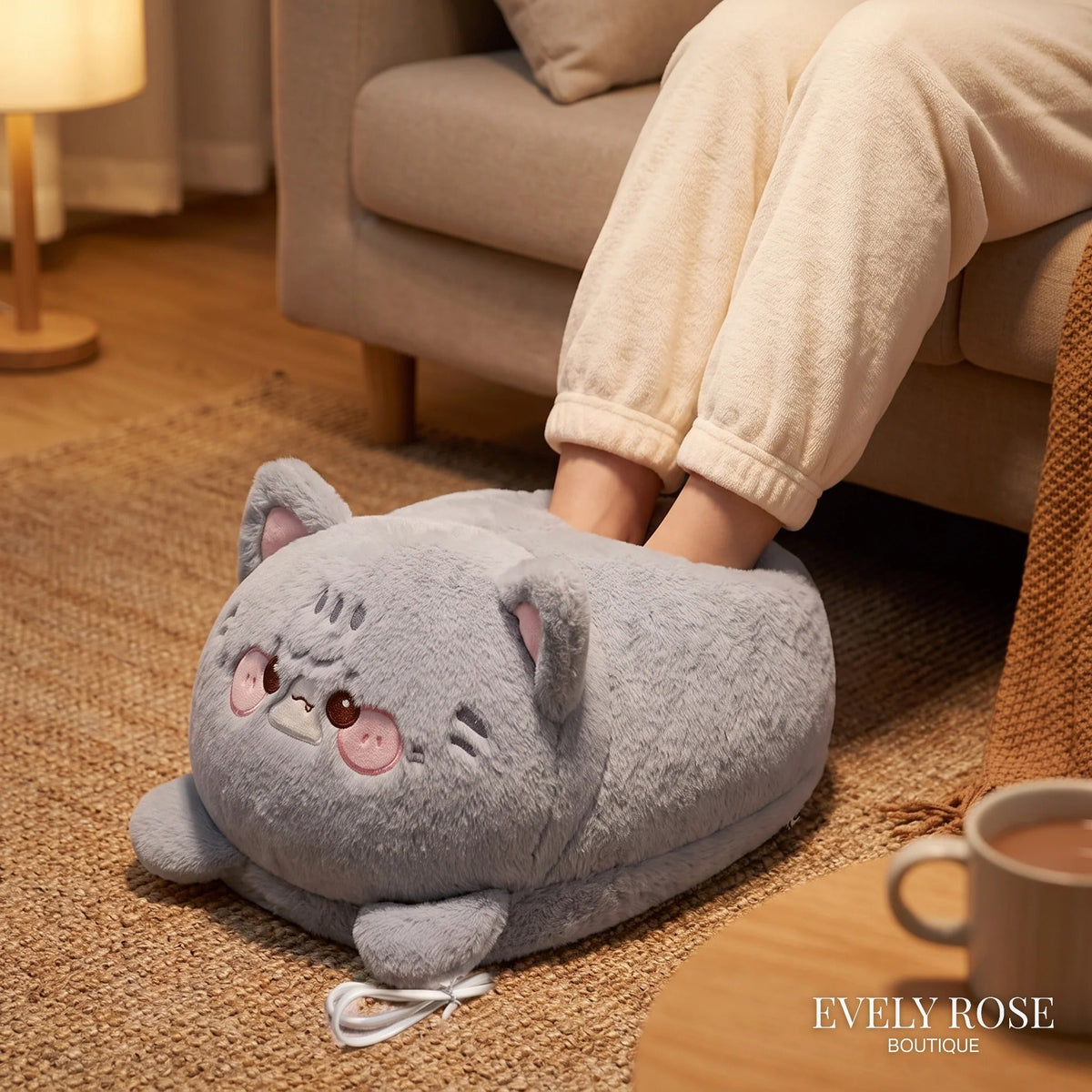 Grey cat electric foot warmer cushion in use