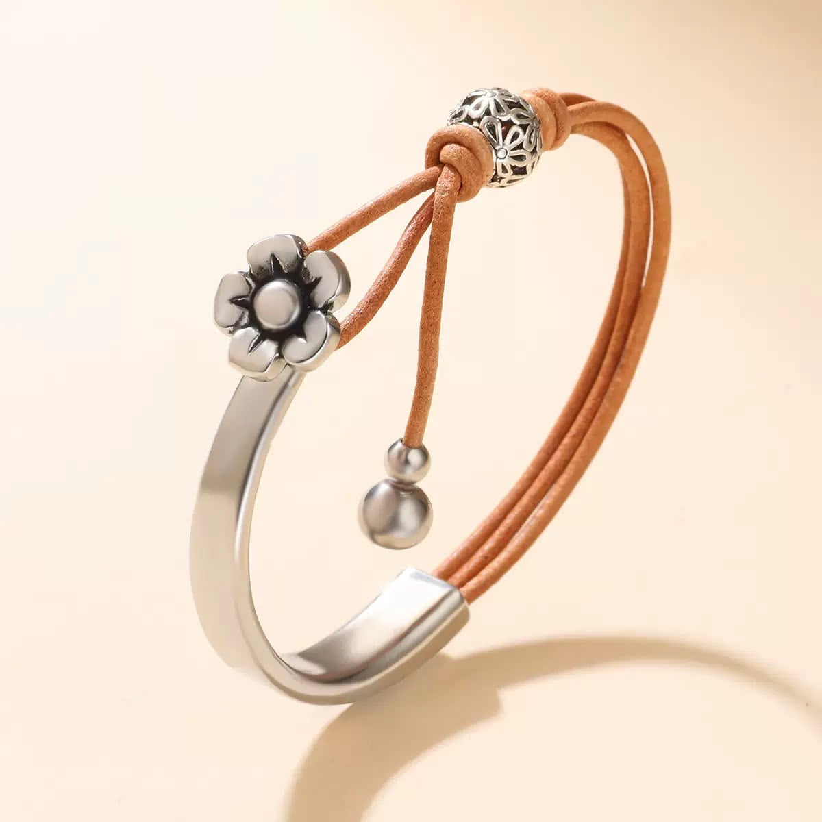 Florence daisy charm leather cuff bracelet — stainless steel half-cuff with tan leather cords and a silver daisy charm