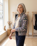 Woman in her 60s wearing the Elspeth houndstooth check zip cardigan in a boutique