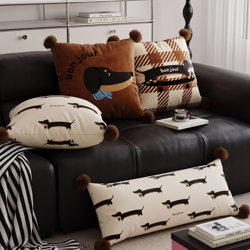 Full bonjour dachshund cushion collection on a dark leather sofa